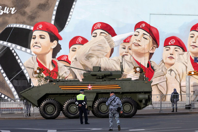 Russian military hardware move along the Garden Ring road against the background of patriotic graffiti heading to Red Square for the Victory Day military parade rehearsal in central Moscow, Russia