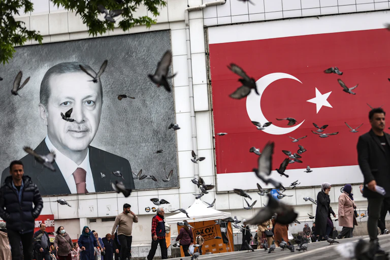 Billboard of Erdogan with birds flying around