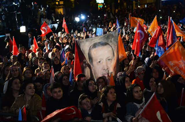 Turkish voters waving flags and posters