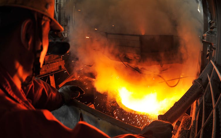 man stands beside furnace