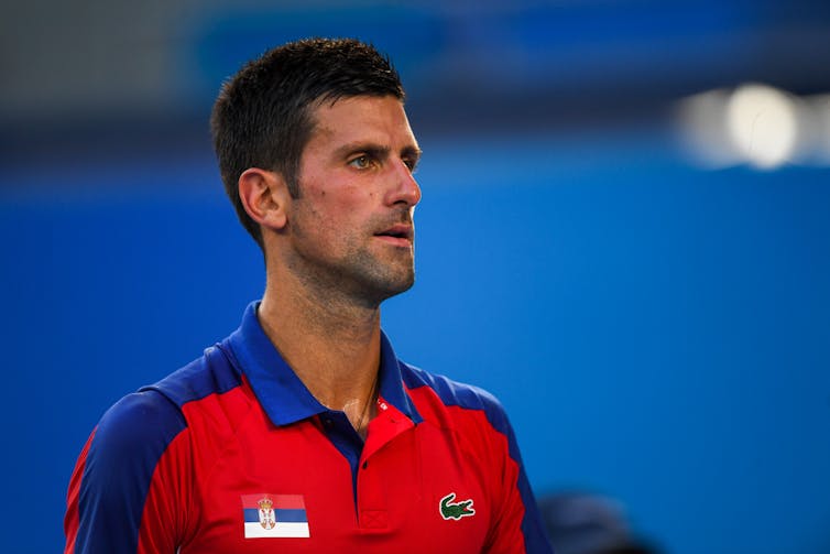 Novak Djokovic in a red shirt.