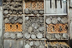 Wood cubes filled with twigs and bricks.