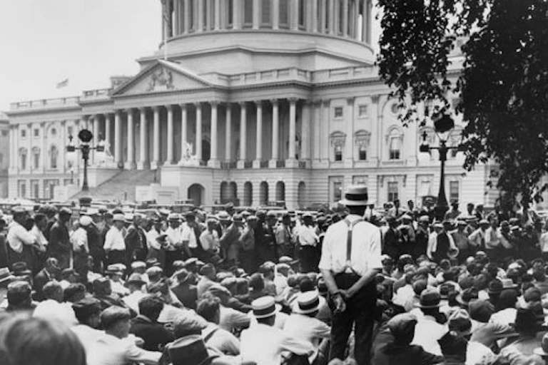 A crowd of men in boaters and white shirts in front of Congress.