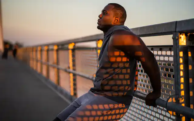 African-Australian man exercises on a handrail