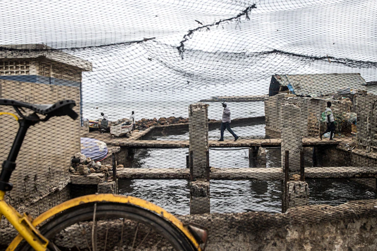 a man walks over a sewage canal