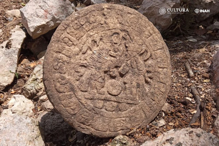 A round stone ball covered in markings.