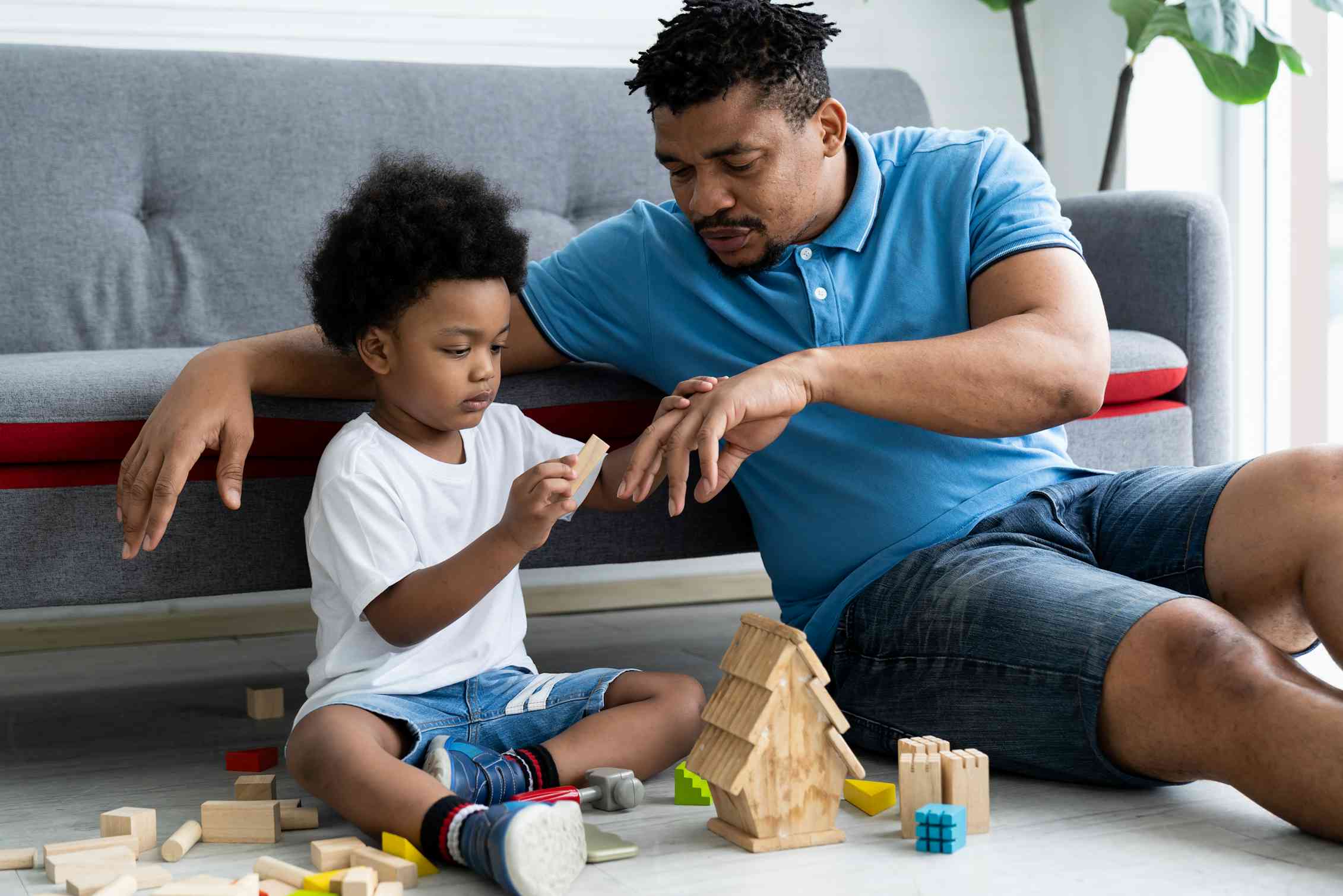 Father and child playing with blocks