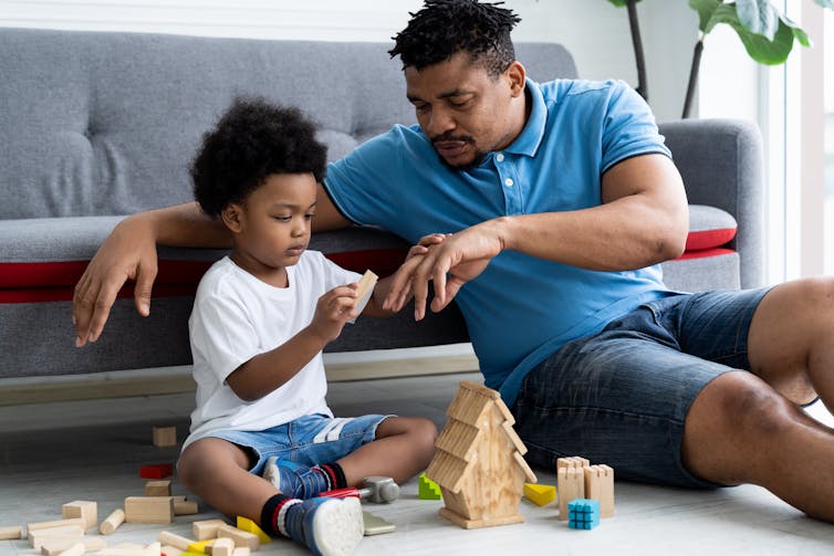 Father and child playing with blocks