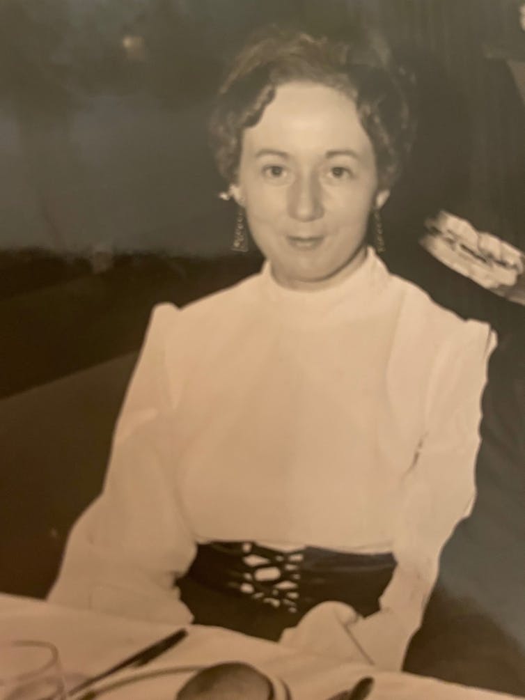 Woman poses for a picture while at a dinner dance.