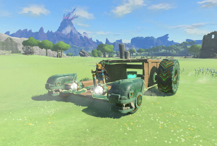 Video game car with large tyres driving on green grass.
