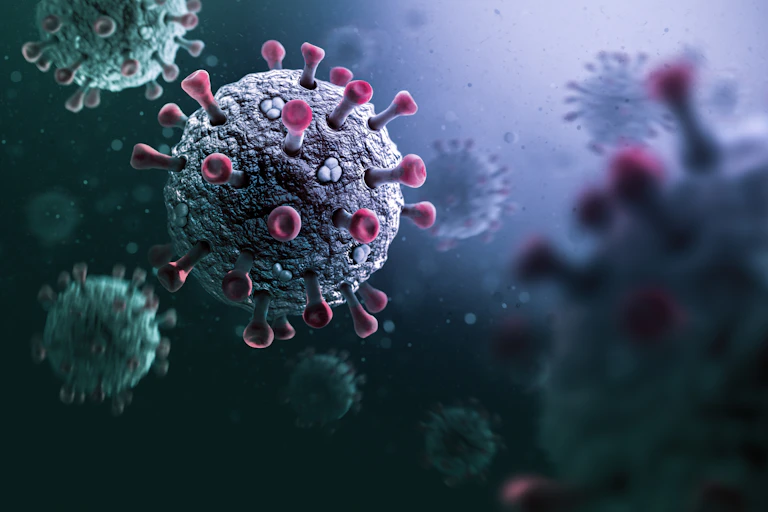 Illustration of different colored COVID-19 viral particles drifting against a dark background.