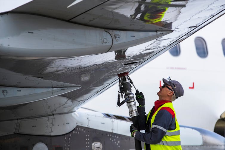 man refuels plane