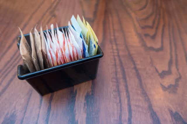 packets of sugar and sweeteners on table top