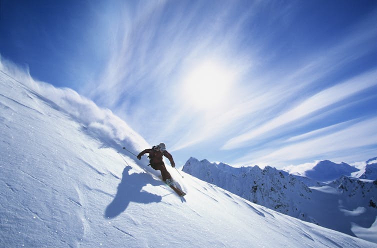 A skier skiing on fresh powder snow.