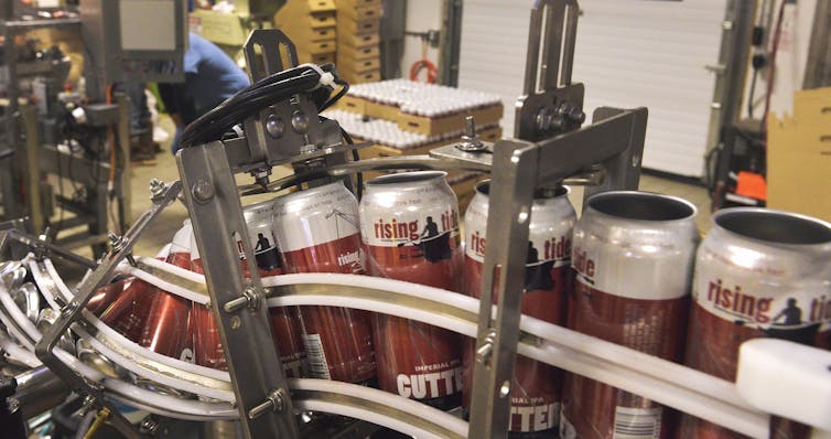 empty beer cans on production line