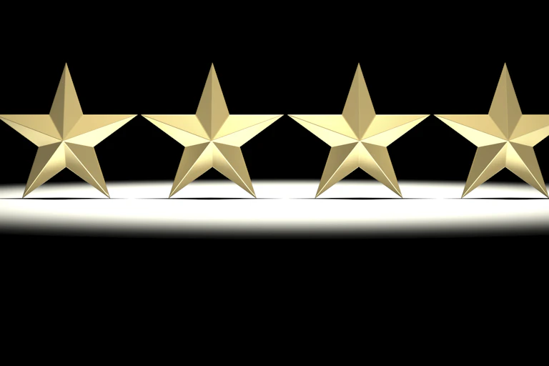 Four golden stars illuminated on a stage