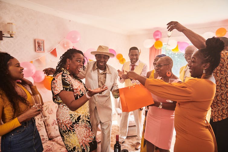 Family and friends in a room celebrating