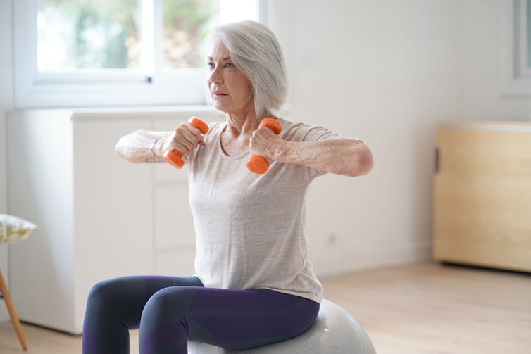Older woman exercises with weights