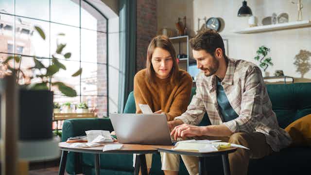A couple at home working on their finances.