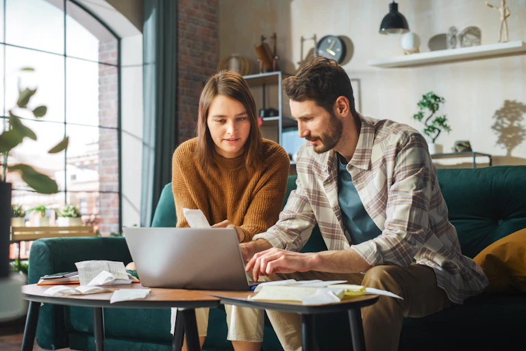 A couple at home working on their finances.