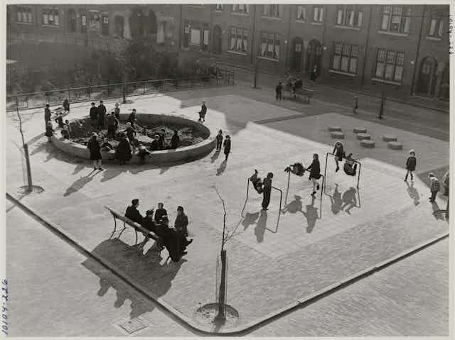 An archival photograph of children playing in a playground.