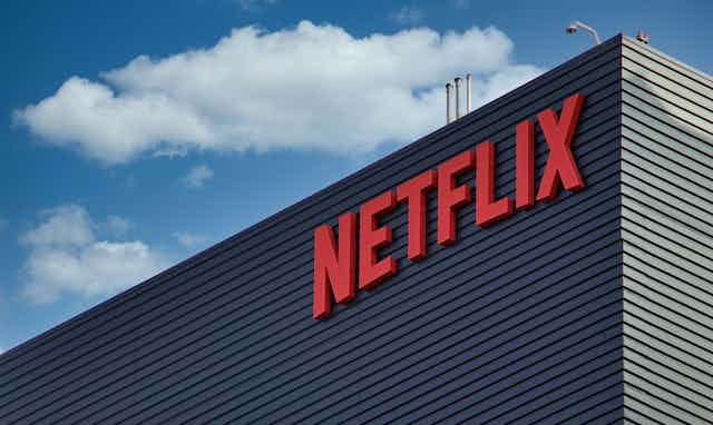 A building that says Netflix is seen against a bright blue sky 