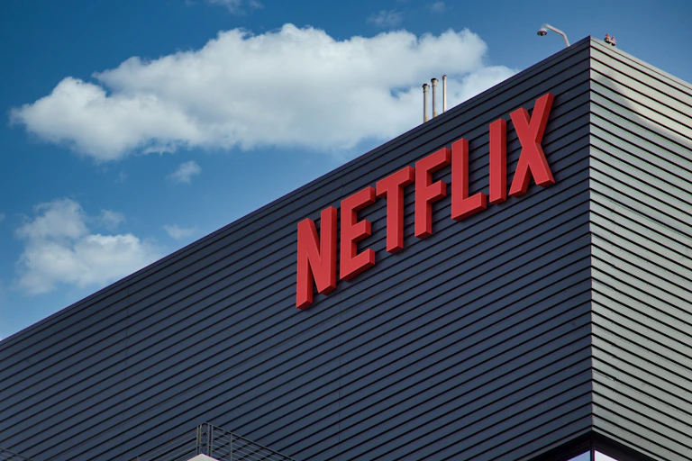 A building that says Netflix is seen against a bright blue sky