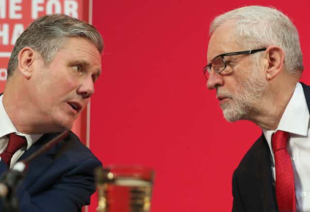 Keir Starmer and Jeremy Corbyn looking at each other