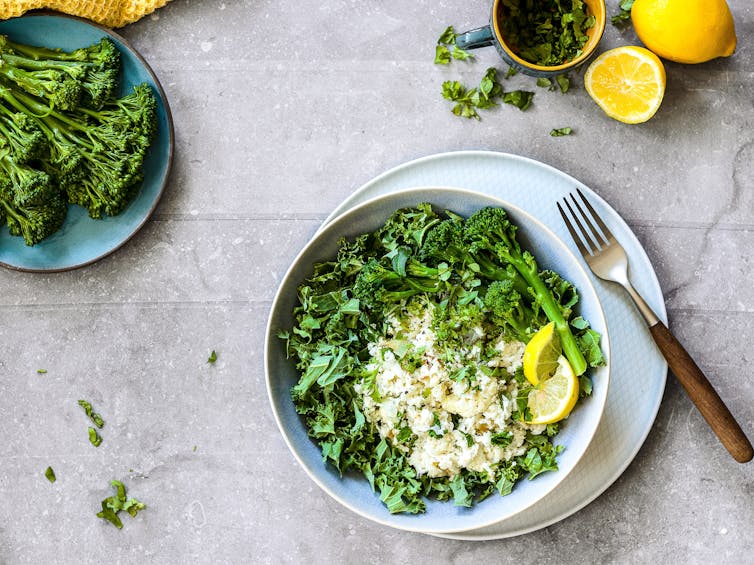 A green salad with rapini on a stone countertop