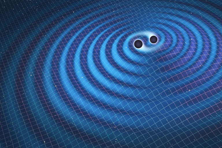Two dark spheres in the center of ripples on a surface.