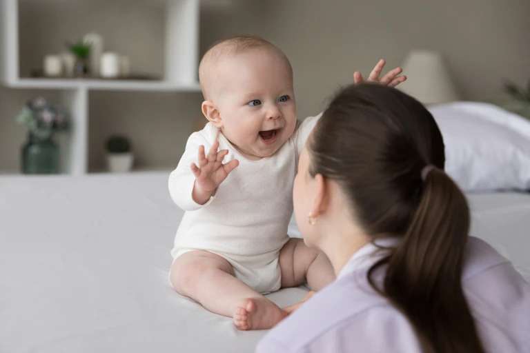 sitting baby looks are woman facing them