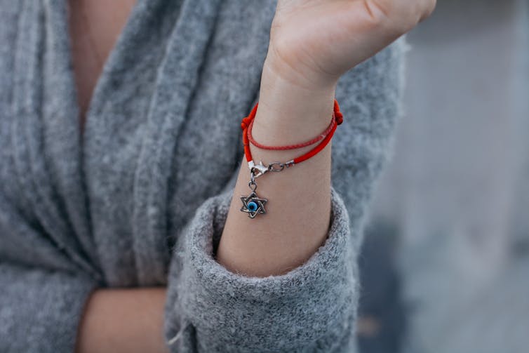 Necklace with the Star of David on a girl's hand