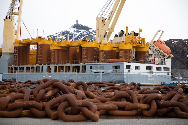 The mooring line for a floating wind turbine at a dock.