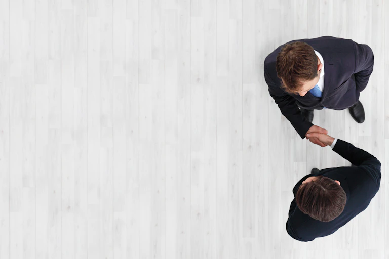 Aerial shot of two businessmen shaking hands
