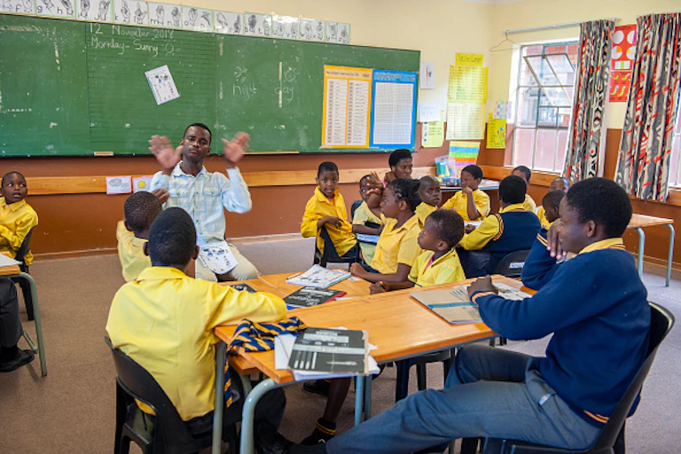 Pupils learning sign language in class.