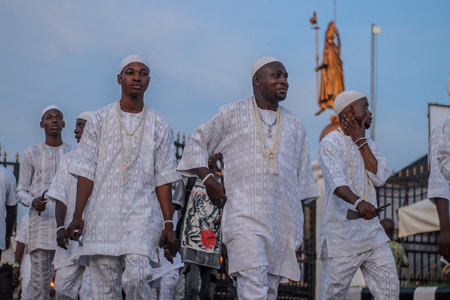 A group of men in traditional Yoruba outfits.