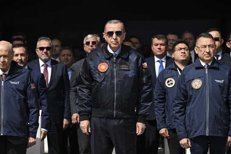 A group of men in dark jackets that have round medallions on them.