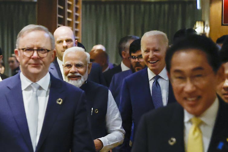 Anthony Albanese, Narendra Modi, Joe Biden and Fumio Kishida walking in a hotel