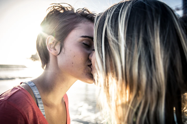 Two young people kissing.