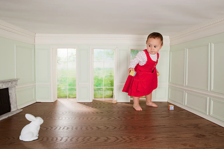 A giant baby. Or a normal-sized baby in a tiny room.