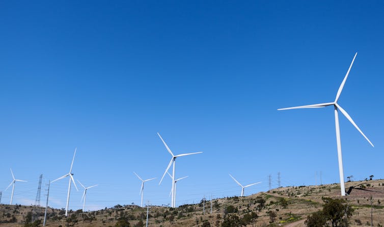 wind turbines against blue sky