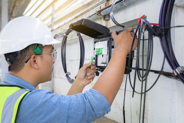 Engineer checking fibre-optic cables
