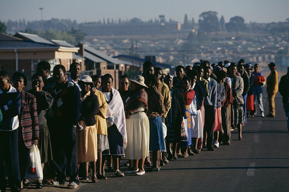 Hundreds of people stand in line to vote in a South African township.
