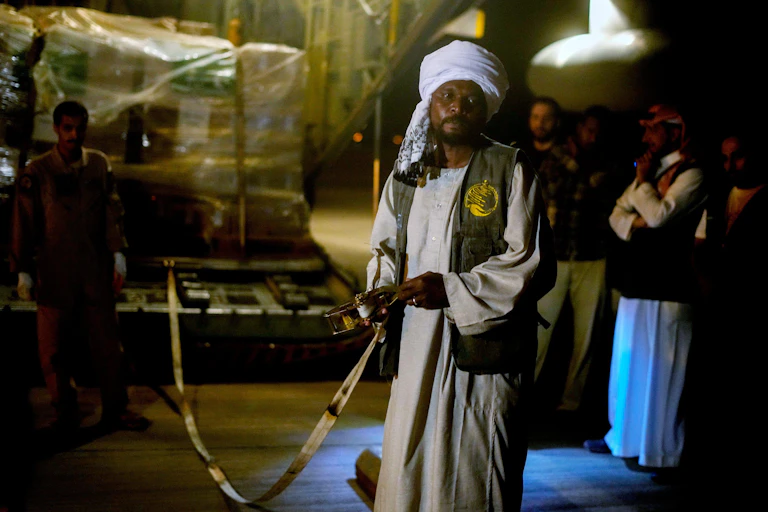 A Sudanese man with aid packages.