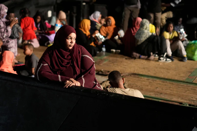 A woman and a child wait to cross the Sudanese border.