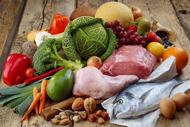 Foods included in the paleo diet including vegetables, buts, chicken, meat, fish, fruit