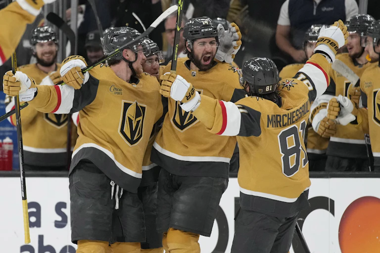 Hockey players celebrating in an ice rink.