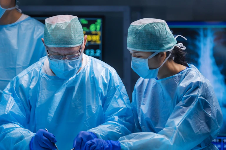 Surgeons operating in theatre