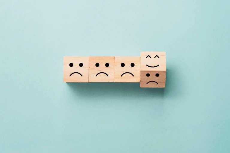 Cubos de madera con caras tristes.