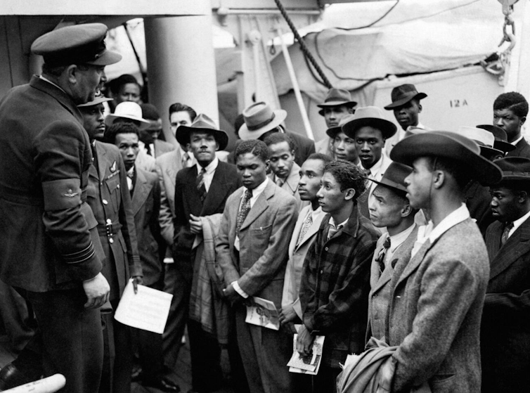 A group of Jamaican men speak to RAF officials in 1948.